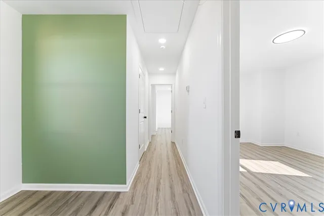 a view of an empty room and wooden floor