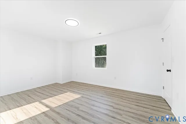 a view of a room with wooden floor