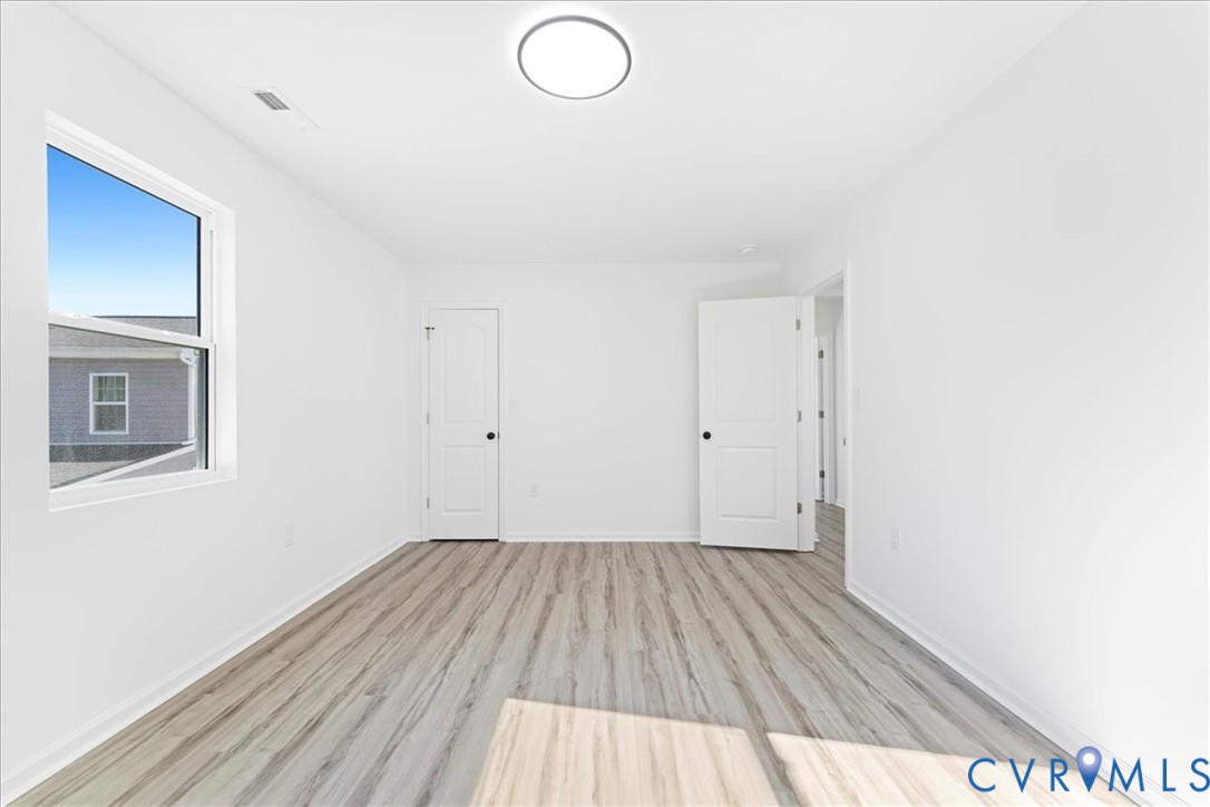 731 Harding Street Petersburg, VA 23803 - Photo 30 of 44 a view of a room with wooden floor and white walls