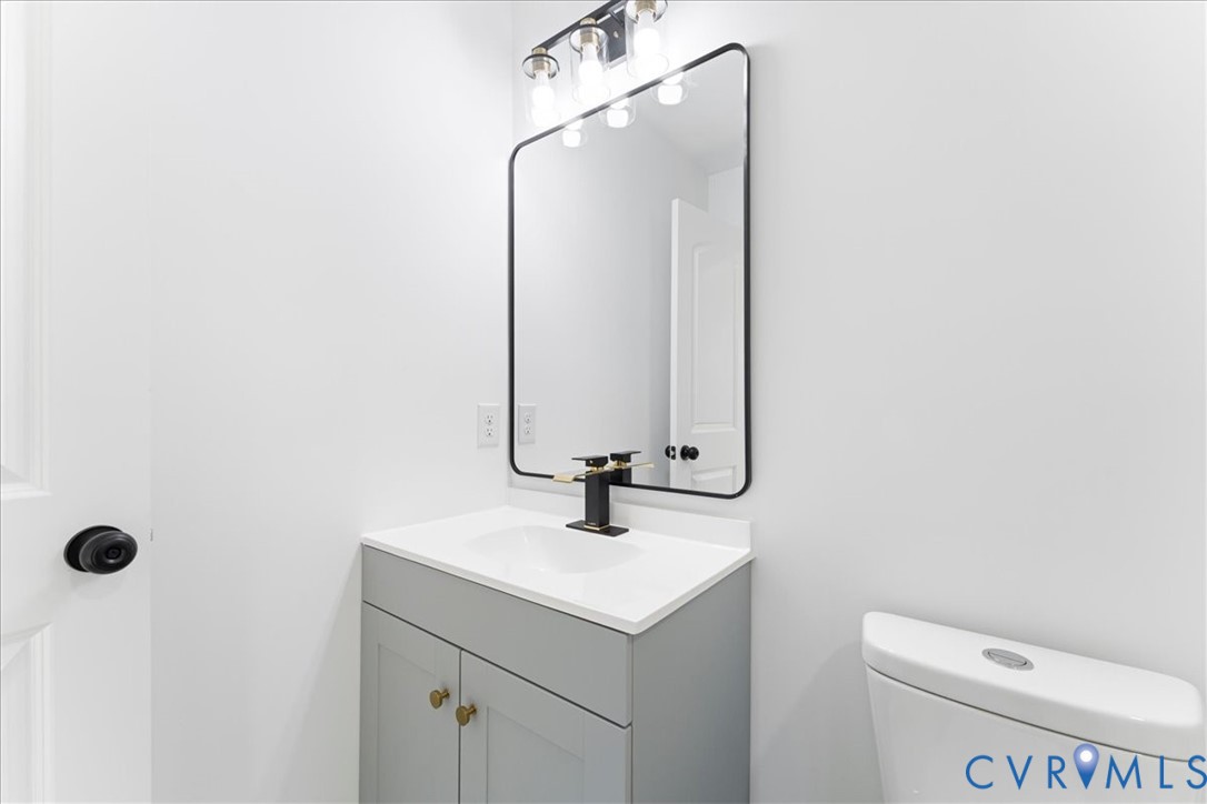 731 Harding Street Petersburg, VA 23803 - Photo 34 of 44 a bathroom with a sink a toilet and mirror
