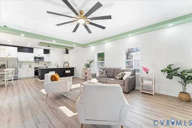 a living room with furniture and a wooden floor