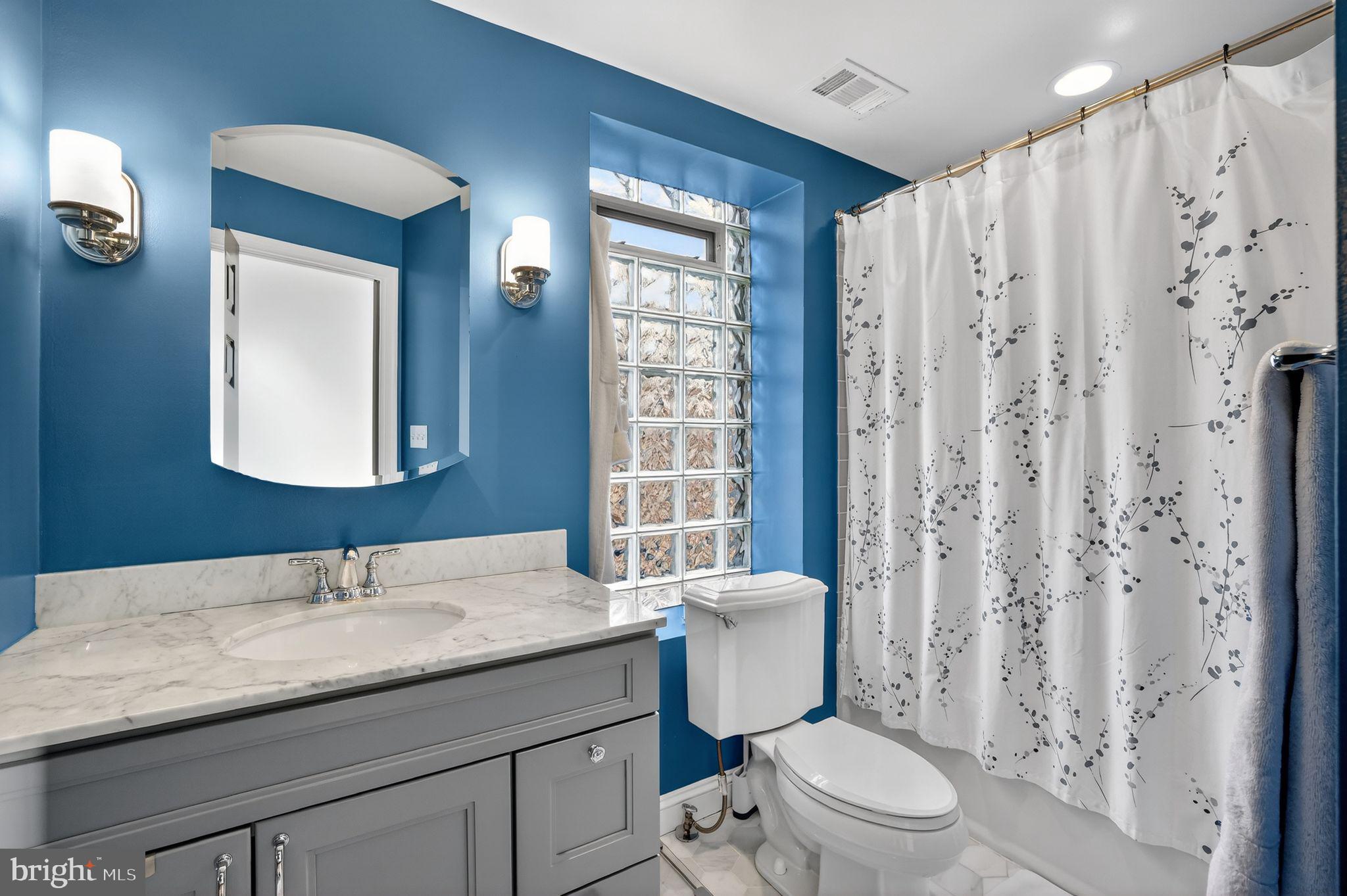 150 Rhode Island Avenue Northwest, Unit 303 Washington, DC 20001 - Photo 16 of 24 a bathroom with a granite countertop sink toilet a mirror and shower
