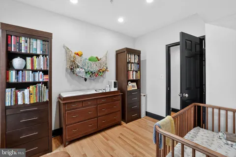 a bedroom with a bed and book shelf