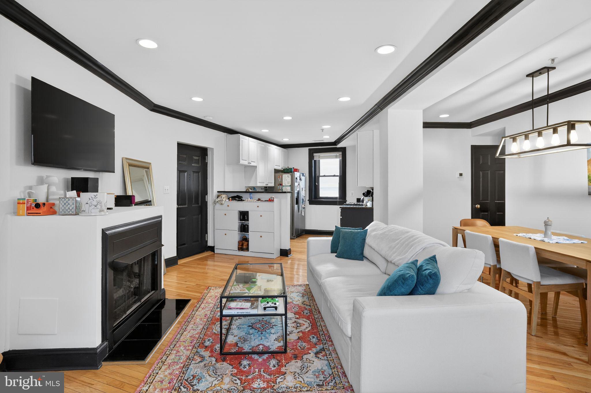 150 Rhode Island Avenue Northwest, Unit 303 Washington, DC 20001 - Photo 3 of 24 a living room with furniture and a flat screen tv