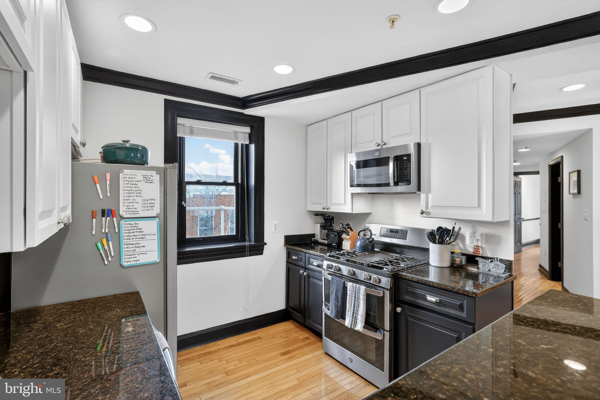 150 Rhode Island Avenue Northwest, Unit 303 Washington, DC 20001 - Photo 10 of 24 a kitchen with stainless steel appliances granite countertop a refrigerator a stove top oven a sink and dishwasher