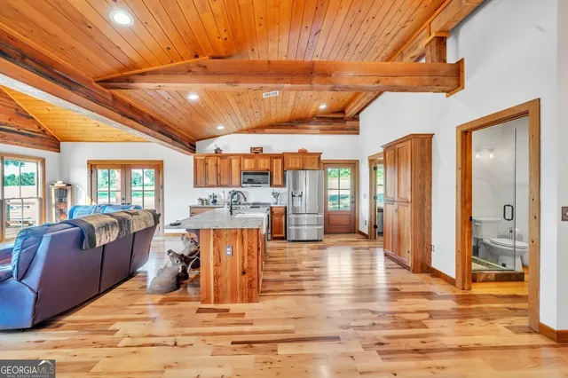a kitchen with stainless steel appliances granite countertop a refrigerator and a stove