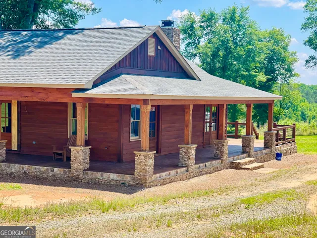 a front view of a house with a yard outdoor seating area and yard