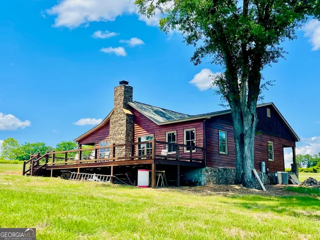 a view of a house with swimming pool and sitting area