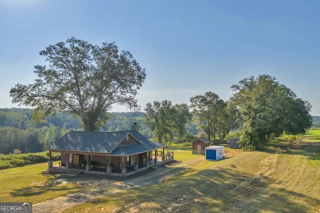 a view of a house with swimming pool and sitting area