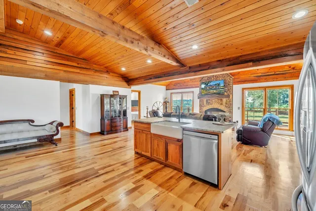 a open kitchen with stainless steel appliances granite countertop a stove and cabinets