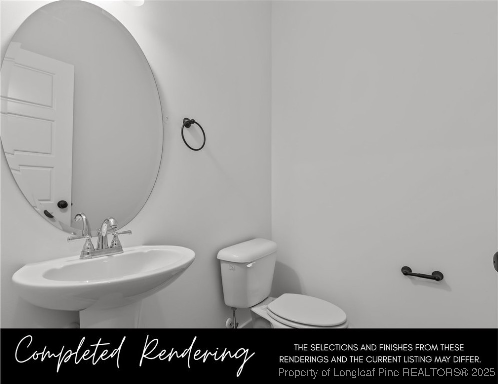 3575 Philippi Church Road Raeford, NC 28376 - Photo 10 of 12 a bathroom with a toilet a sink and mirror