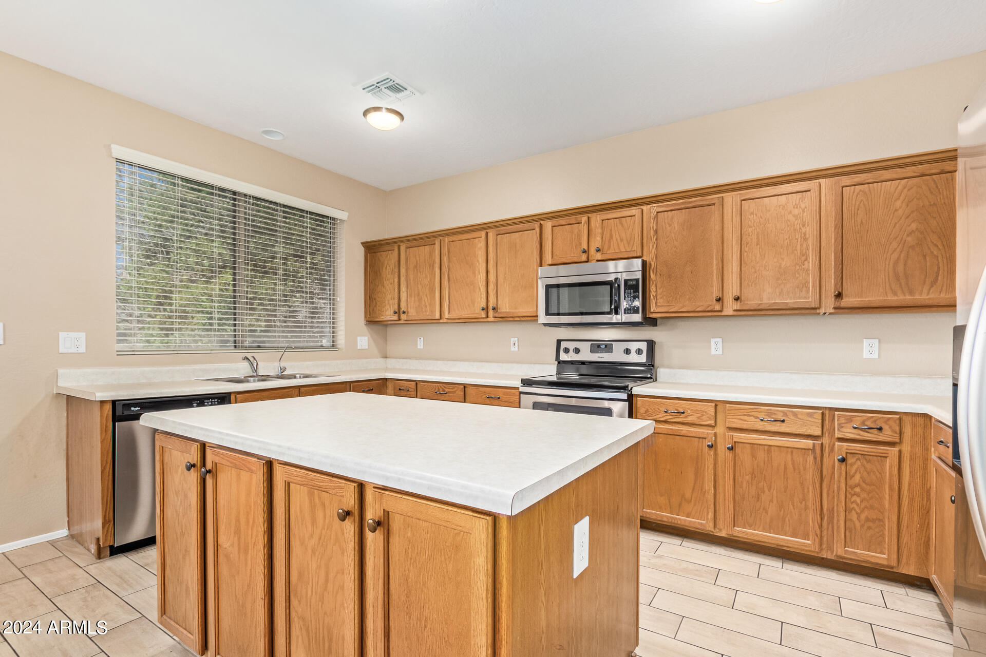 504 North Swallow Lane Gilbert, AZ 85234 - Photo 14 of 54 a kitchen with stainless steel appliances granite countertop a sink stove and refrigerator