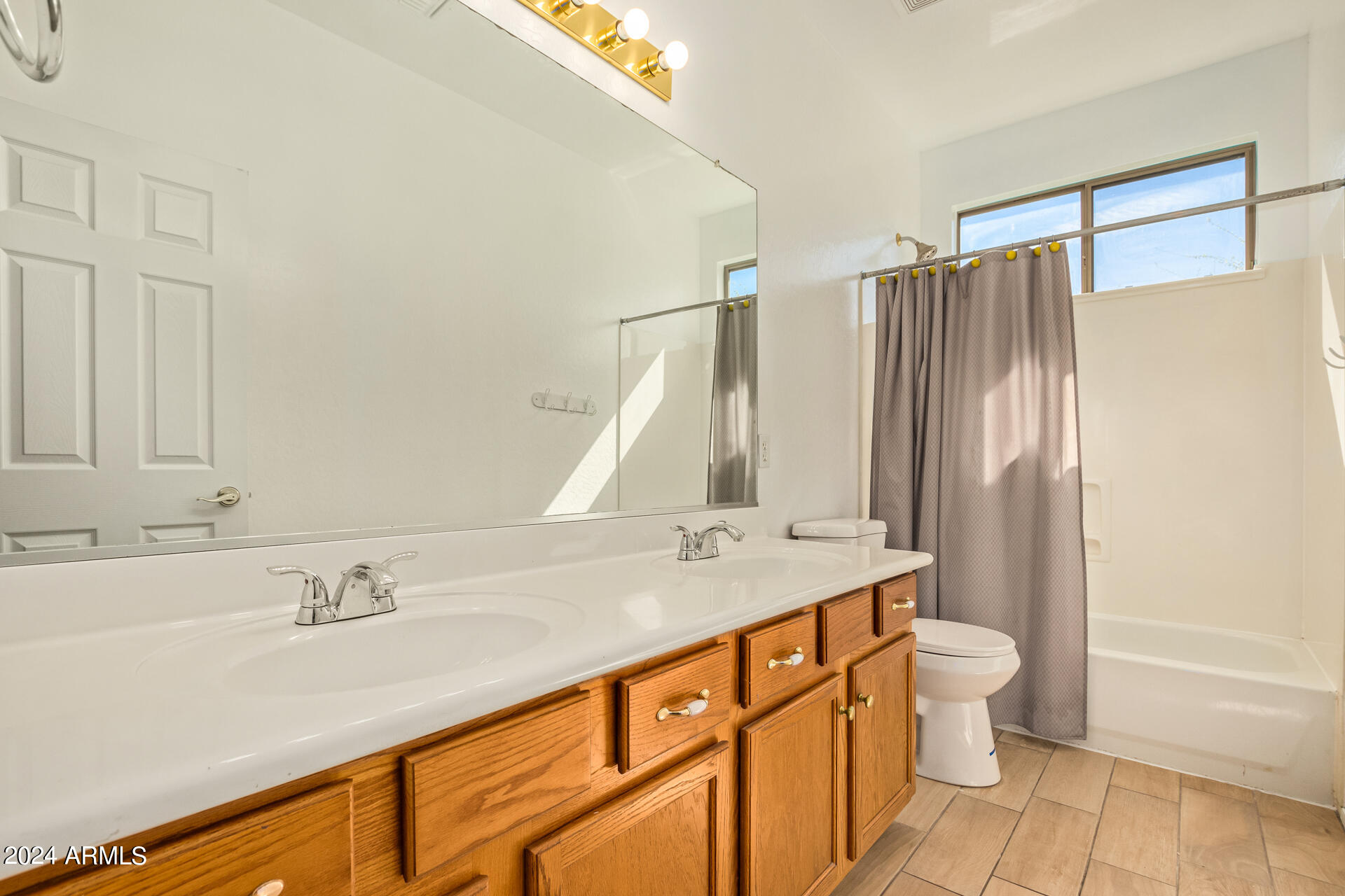 504 North Swallow Lane Gilbert, AZ 85234 - Photo 16 of 54 a bathroom with a granite countertop sink and a mirror