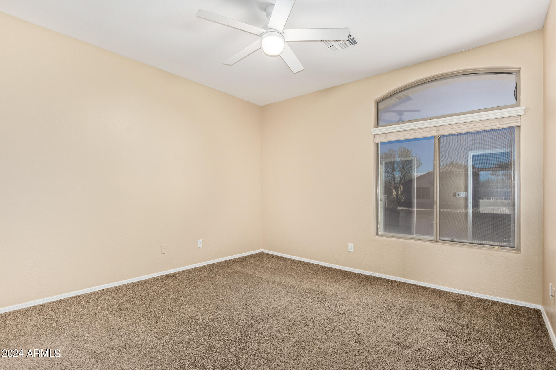 504 North Swallow Lane Gilbert, AZ 85234 - Photo 18 of 54 an empty room with a window and ceiling fan