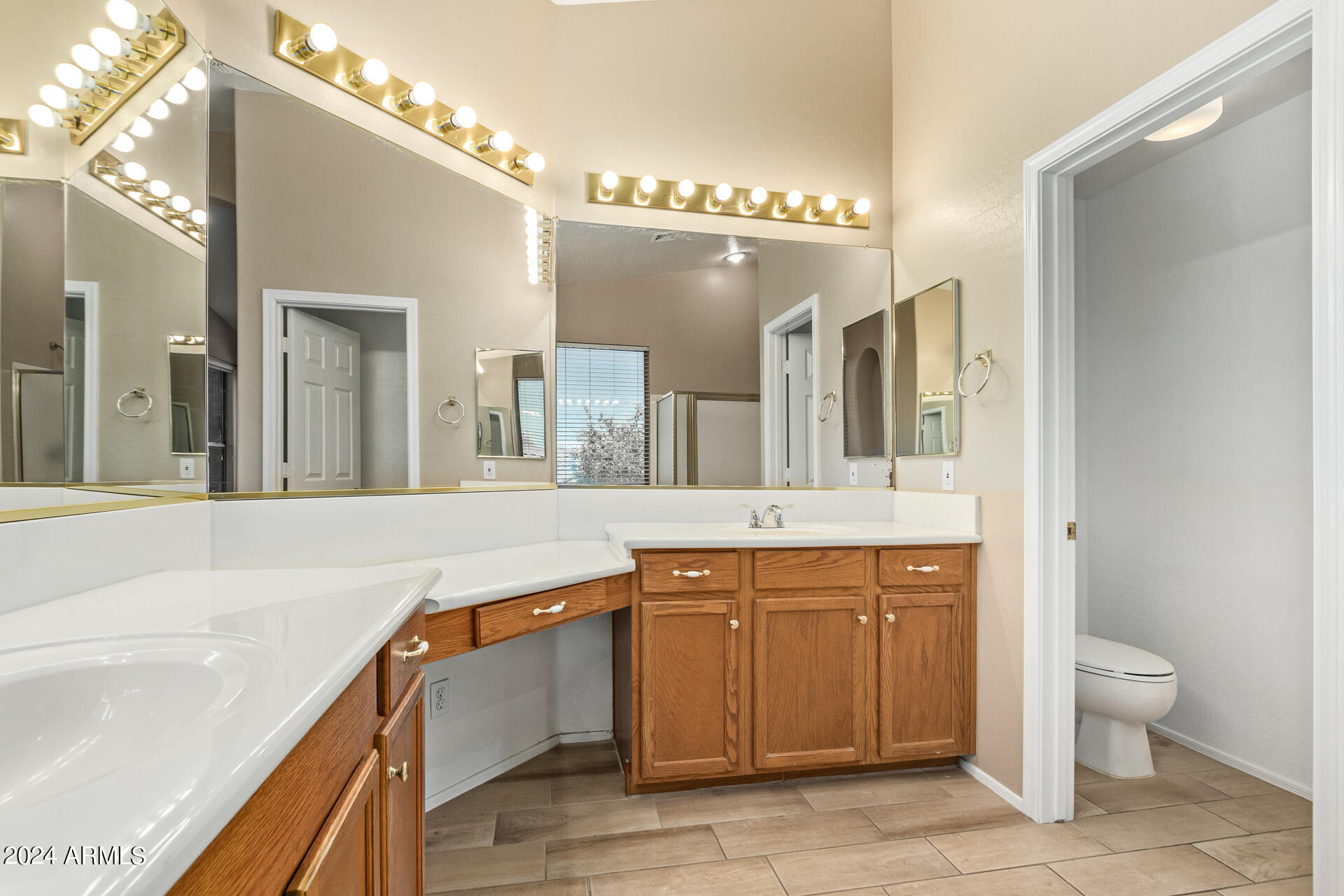 504 North Swallow Lane Gilbert, AZ 85234 - Photo 31 of 54 a spacious bathroom with a sink a large mirror and a toilet