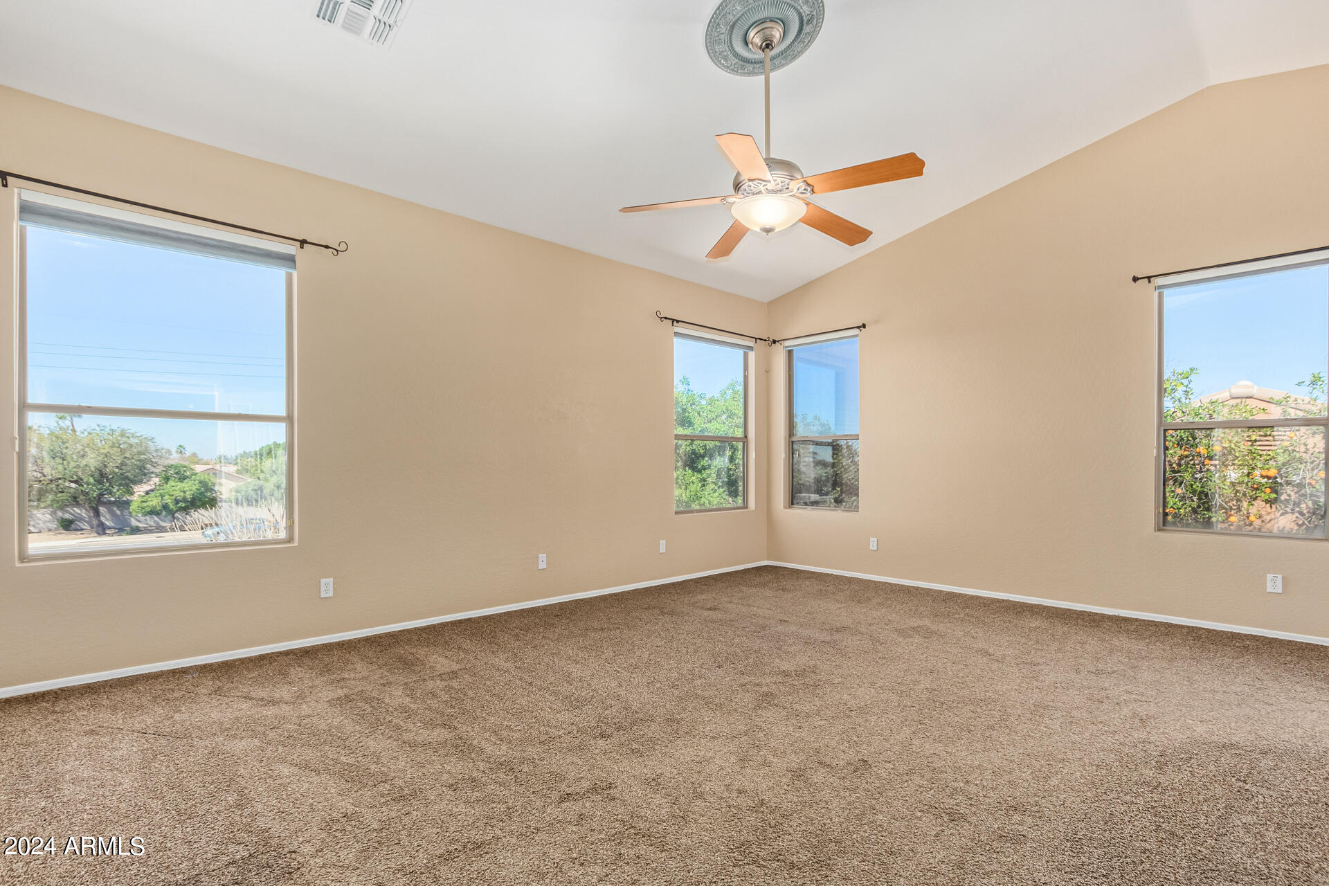 504 North Swallow Lane Gilbert, AZ 85234 - Photo 32 of 54 an empty room with windows and fan view