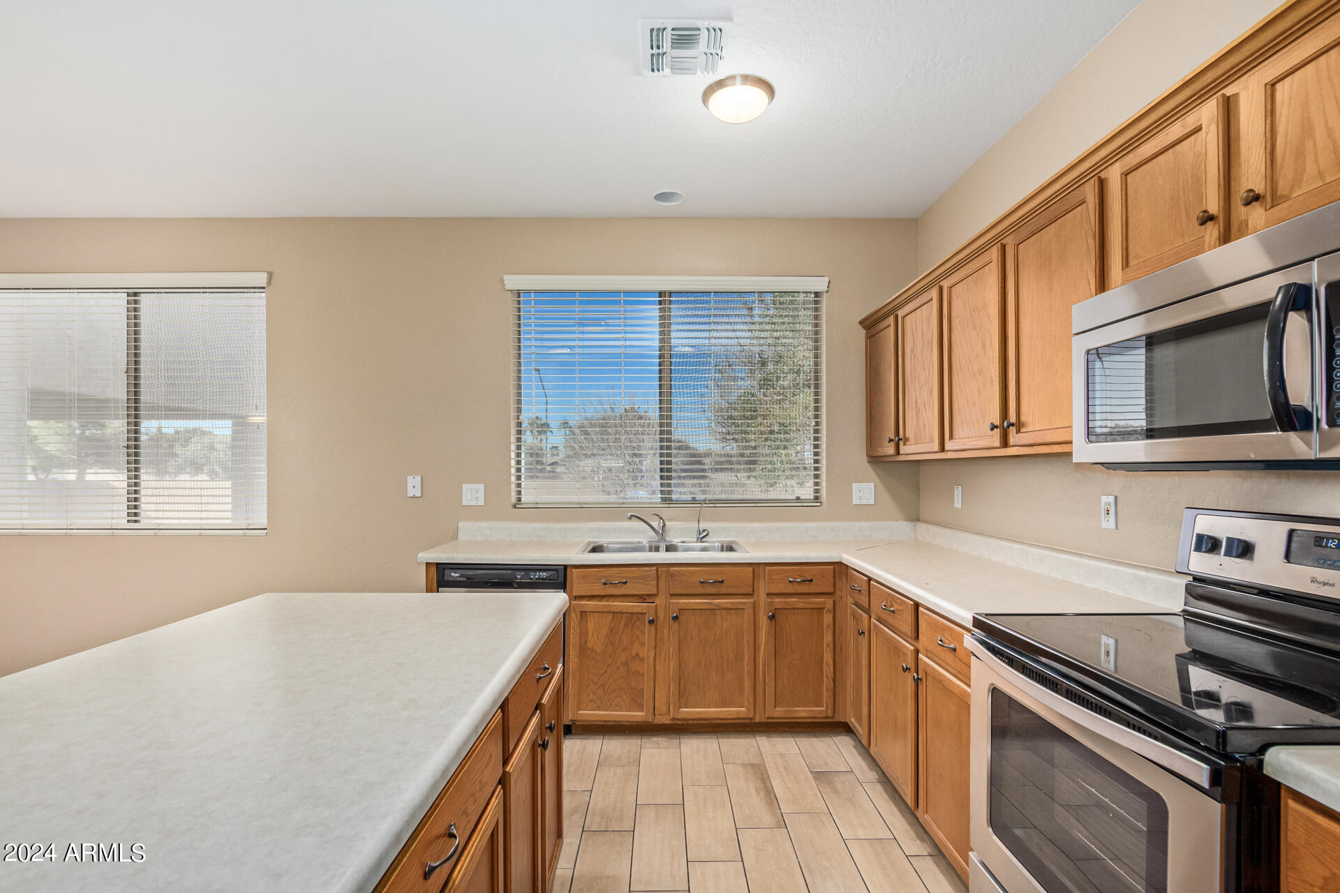 504 North Swallow Lane Gilbert, AZ 85234 - Photo 40 of 54 a kitchen with a sink stove top oven and microwave