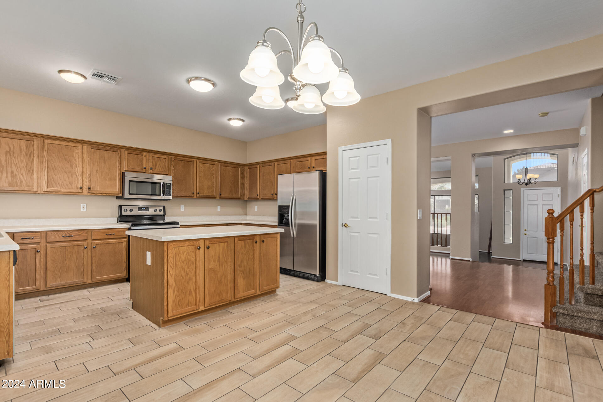 504 North Swallow Lane Gilbert, AZ 85234 - Photo 42 of 54 a kitchen with stainless steel appliances granite countertop a refrigerator and a sink