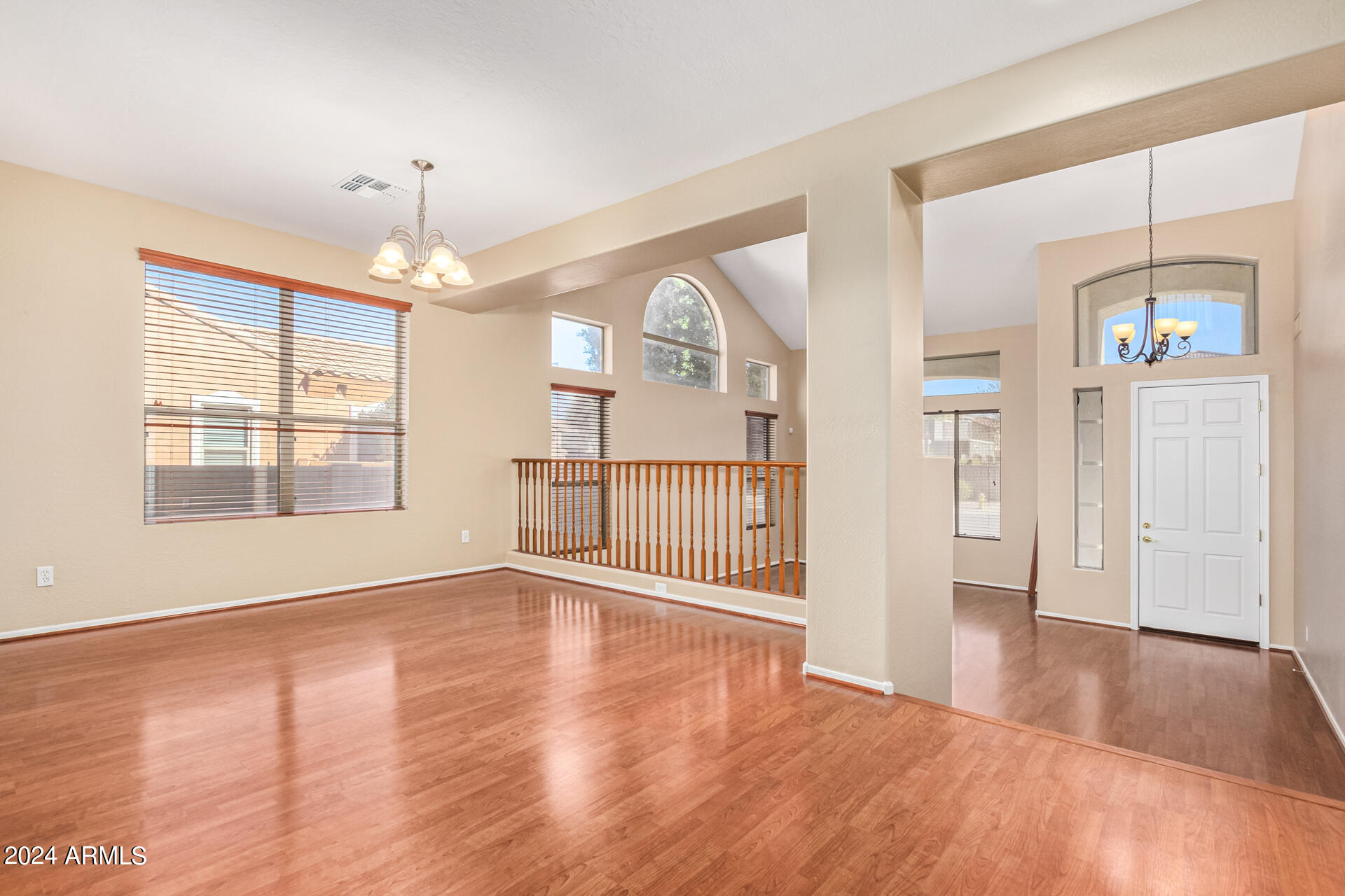 504 North Swallow Lane Gilbert, AZ 85234 - Photo 5 of 54 an empty room with wooden floor chandelier and windows