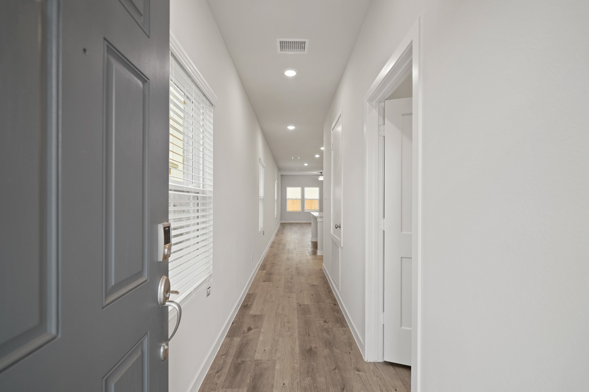 17143 King Eider Road Waller, TX 77484 - Photo 3 of 29 a view of a hallway with wooden floor and staircase