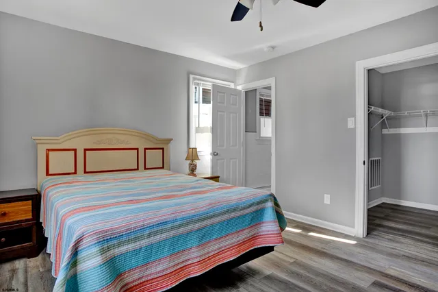 a bedroom with a bed and a large mirror