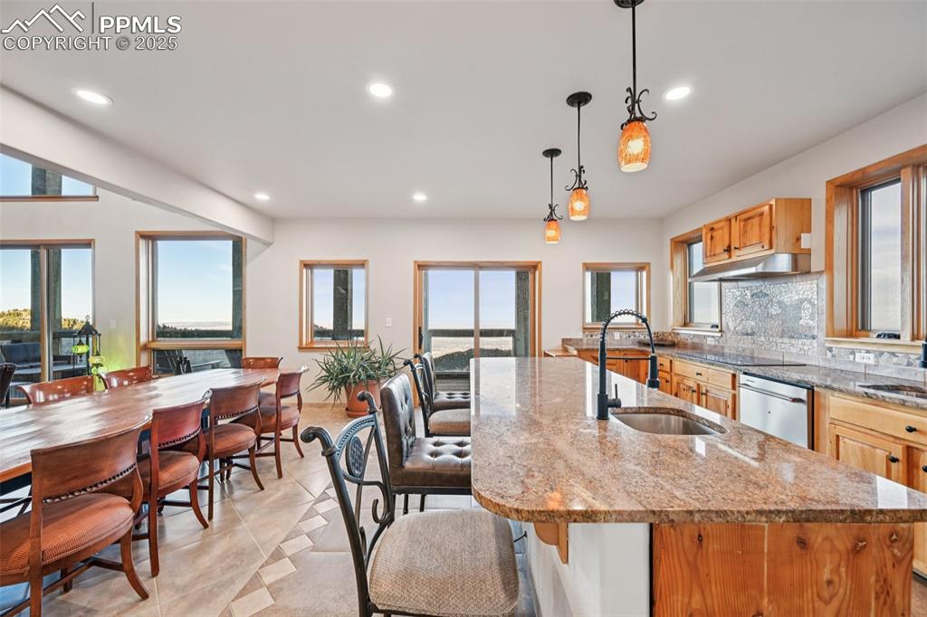 1417 Forest Road Manitou Springs, CO 80829 - Photo 16 of 50 a view of a dining room and livingroom with furniture wooden floor a chandelier