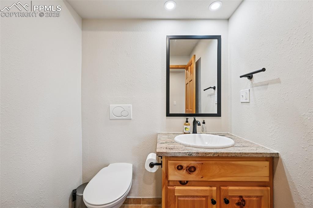 1417 Forest Road Manitou Springs, CO 80829 - Photo 20 of 50 a bathroom with a toilet sink and mirror