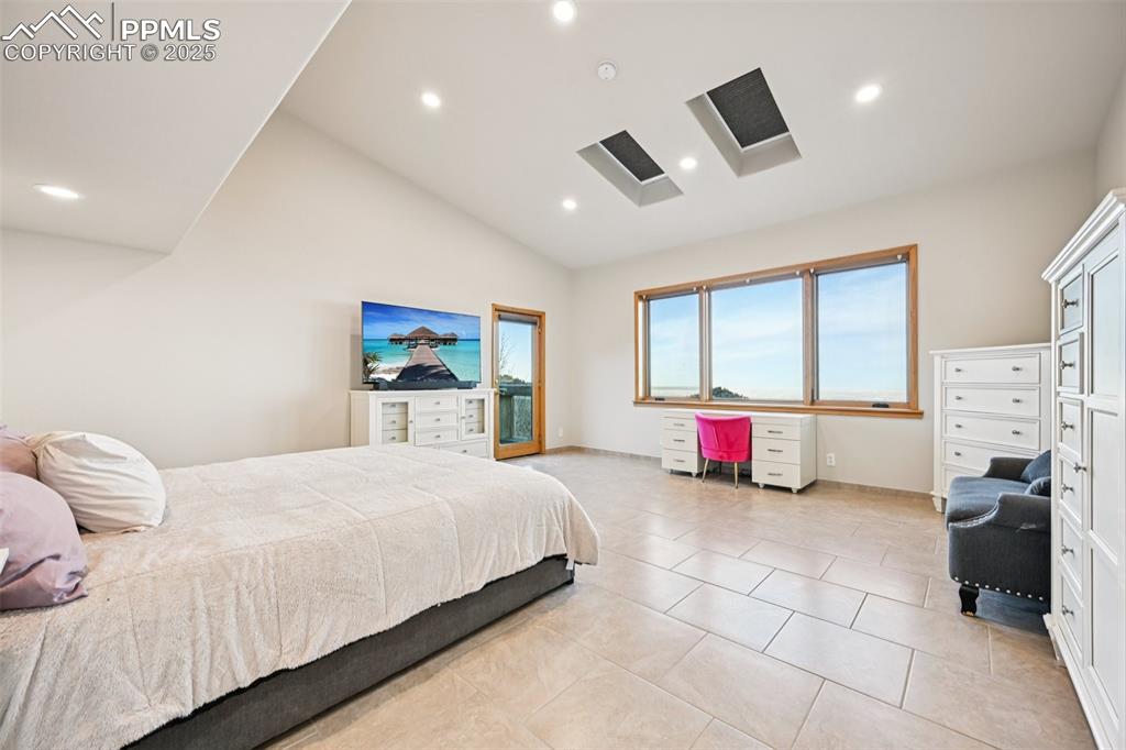 1417 Forest Road Manitou Springs, CO 80829 - Photo 21 of 50 a bedroom with a bed and glass windows