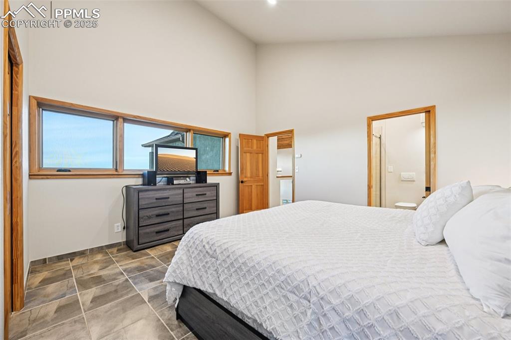 1417 Forest Road Manitou Springs, CO 80829 - Photo 29 of 50 a bedroom with a bed and flat screen tv