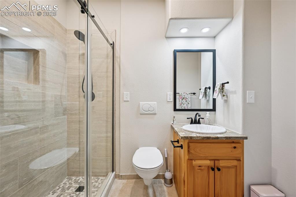 1417 Forest Road Manitou Springs, CO 80829 - Photo 30 of 50 a bathroom with a granite countertop sink toilet and shower