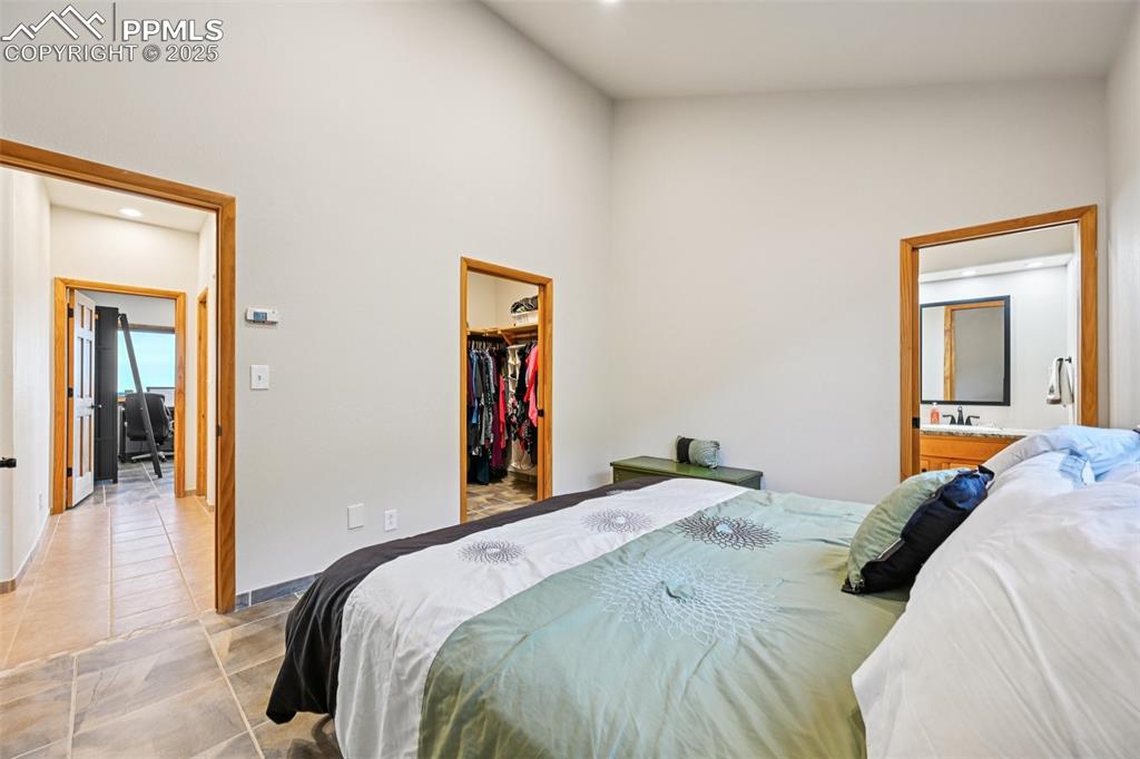 1417 Forest Road Manitou Springs, CO 80829 - Photo 31 of 50 a bedroom with a bed and a mirror