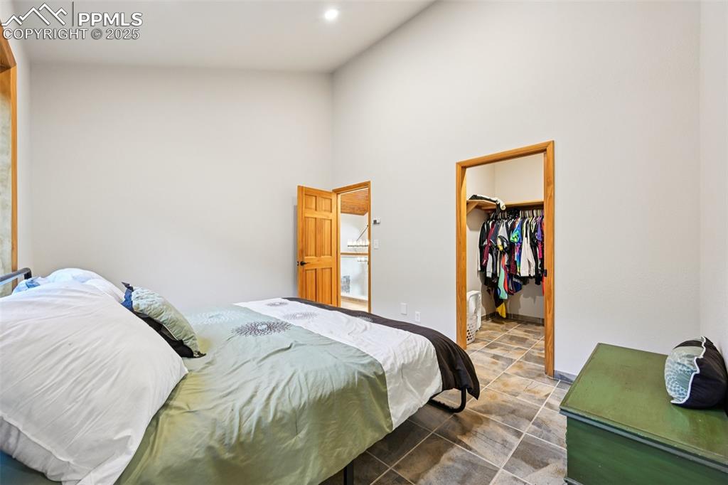 1417 Forest Road Manitou Springs, CO 80829 - Photo 32 of 50 a bed sitting in a bedroom next to a window