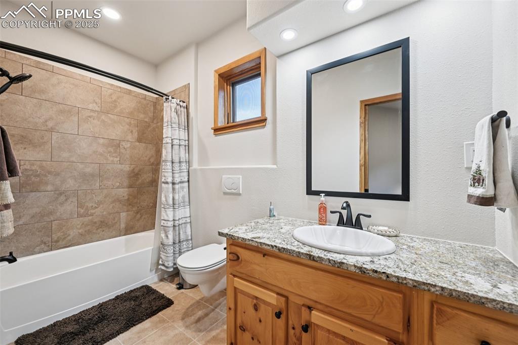 1417 Forest Road Manitou Springs, CO 80829 - Photo 33 of 50 a bathroom with a granite countertop sink toilet and shower