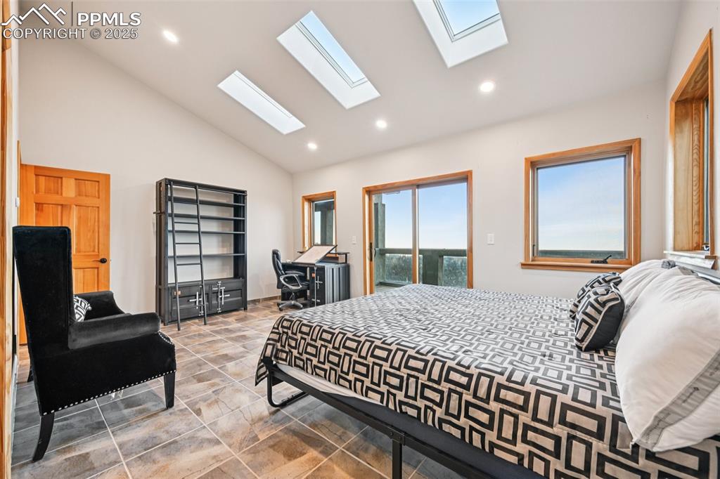 1417 Forest Road Manitou Springs, CO 80829 - Photo 34 of 50 a bedroom with a bed a couch and a window