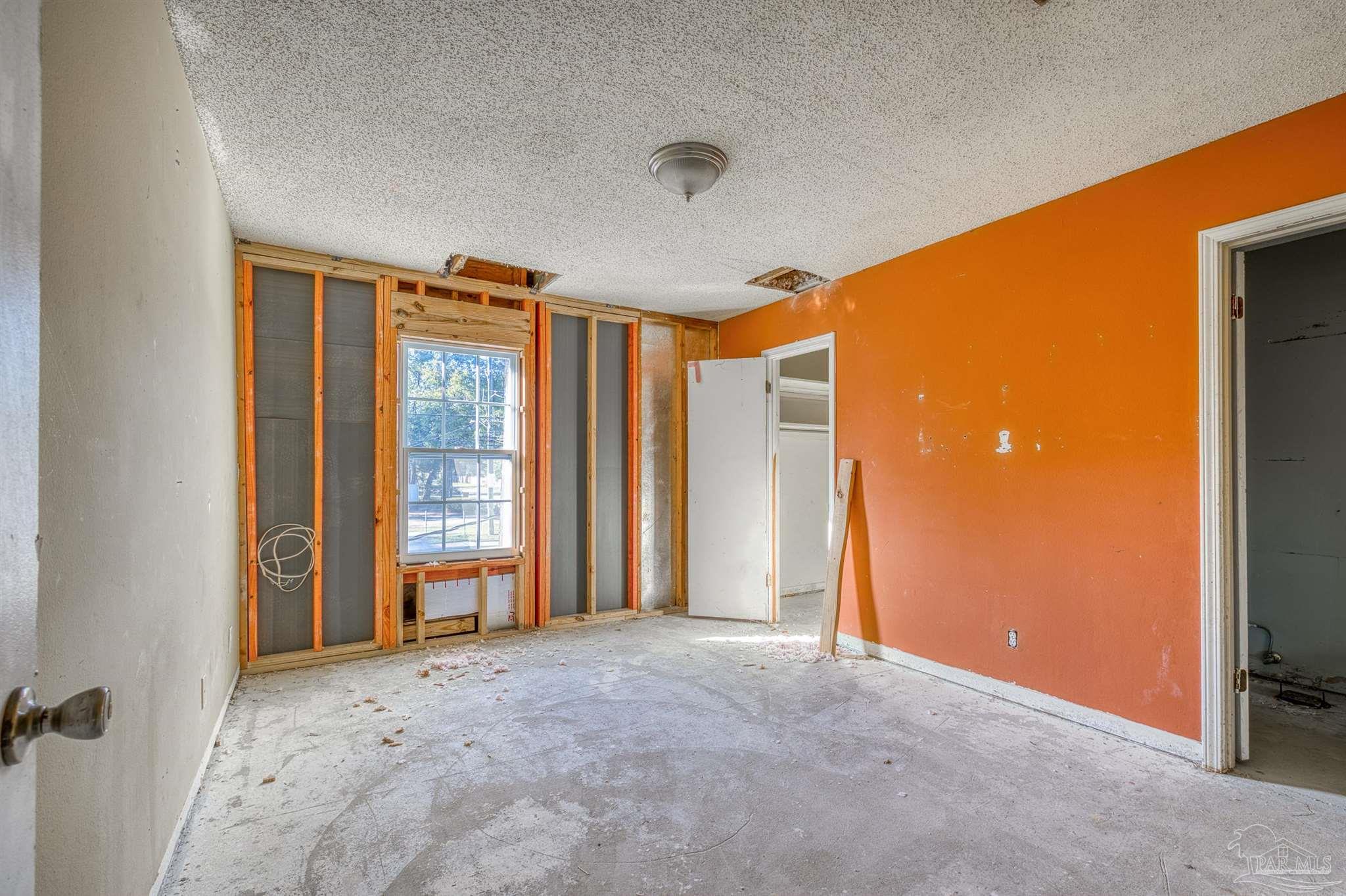 8101 Tippin Avenue, Unit D Pensacola, FL 32514 - Photo 13 of 18 an empty room with windows and closet