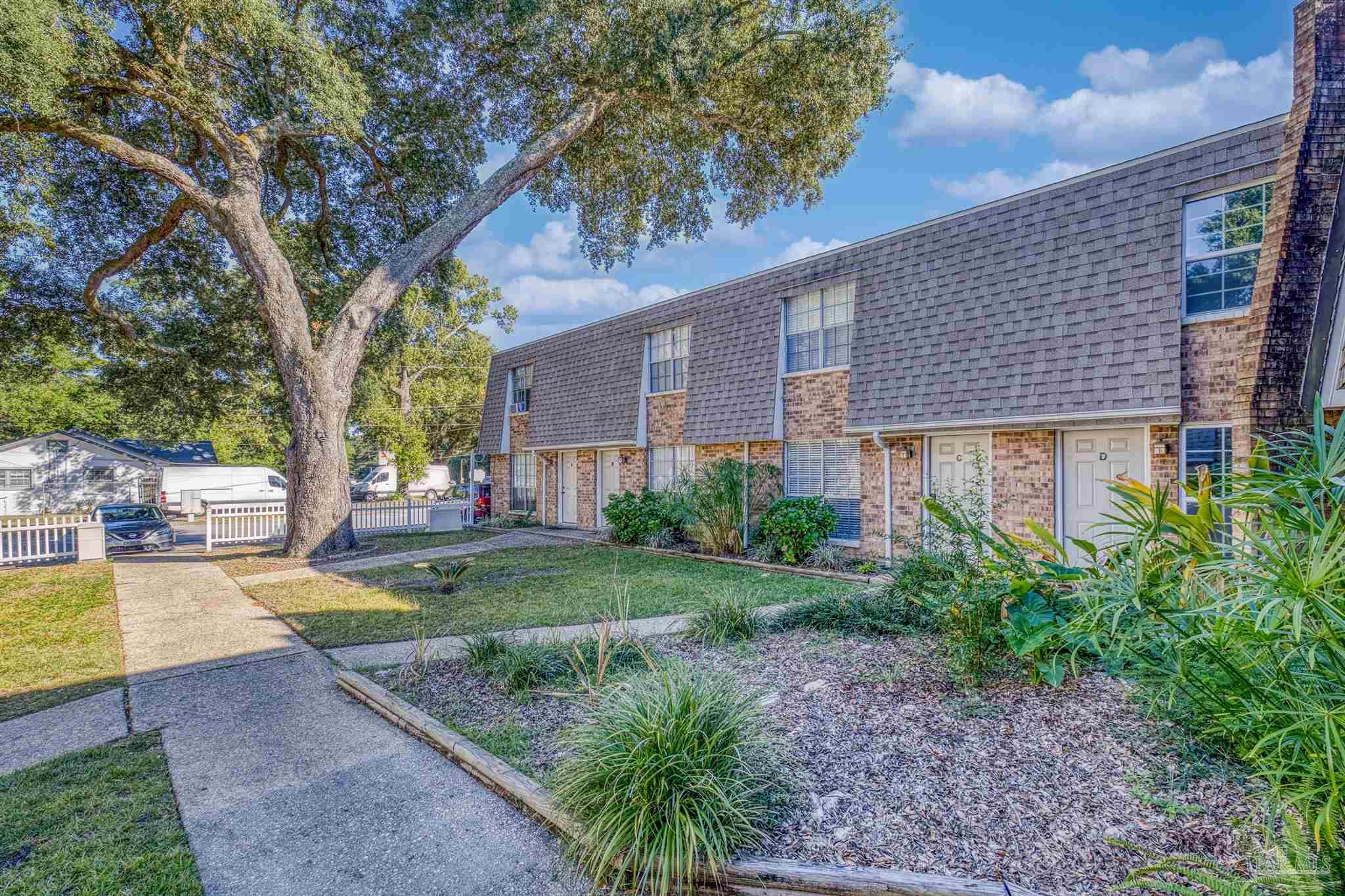 8101 Tippin Avenue, Unit D Pensacola, FL 32514 - Photo 18 of 18 a front view of a house with garden