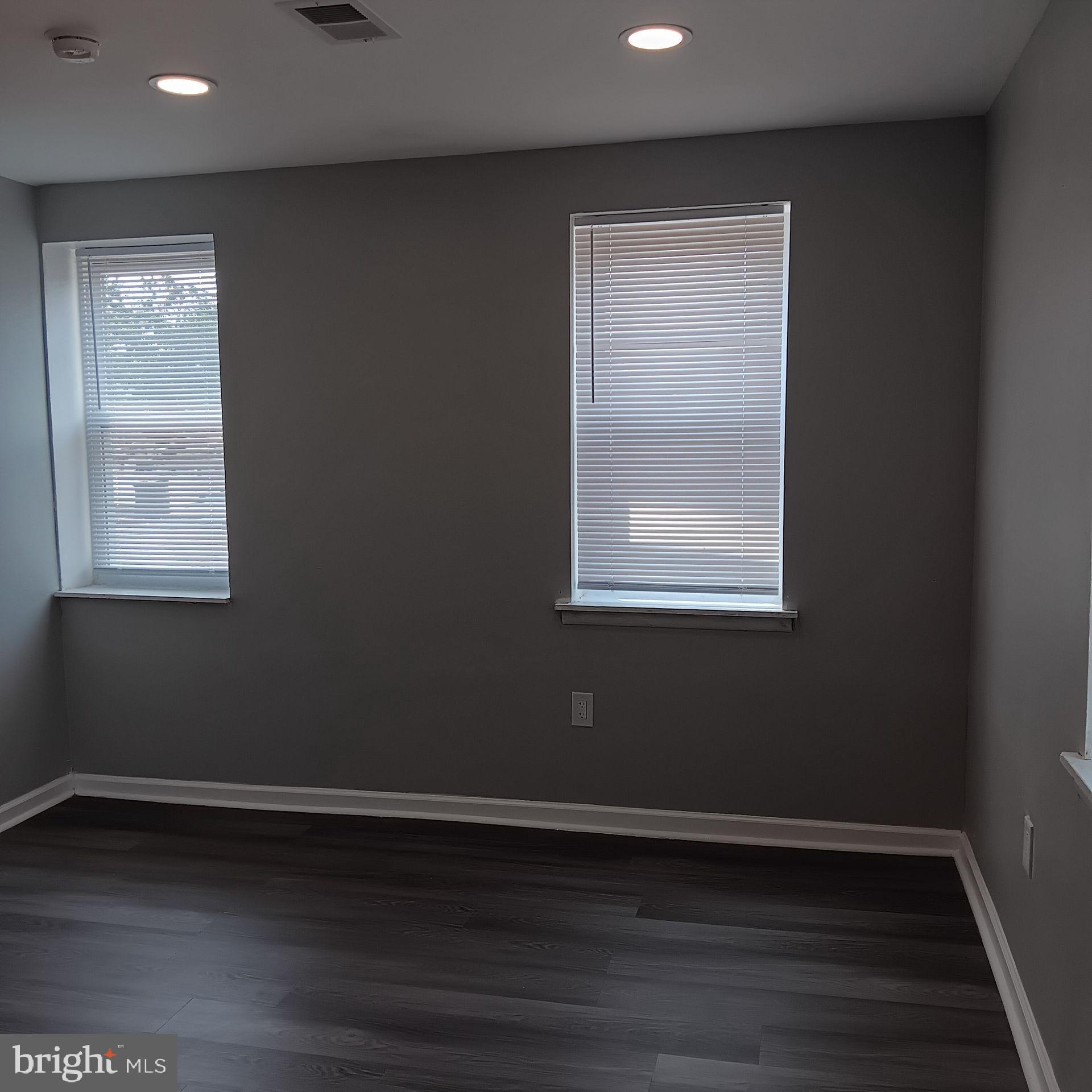 2036 North Gratz Street, Unit 2 Philadelphia, PA 19121 - Photo 13 of 14 a view of an empty room with wooden floor and a window