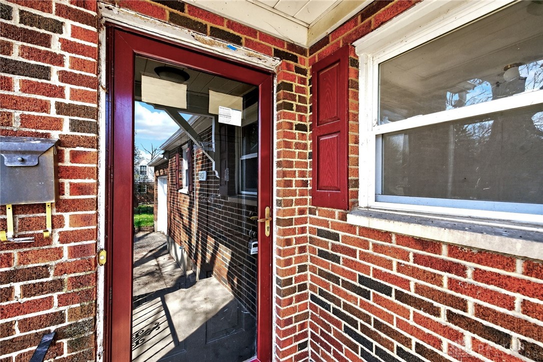 1243 Ridgeview Avenue Dayton, OH 45409 - Photo 7 of 56 This classic brick exterior features charming red shutters and a welcoming glass-paneled door.