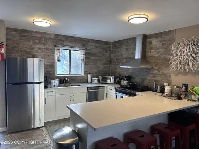 a bathroom with a granite countertop shower mirror and a sink