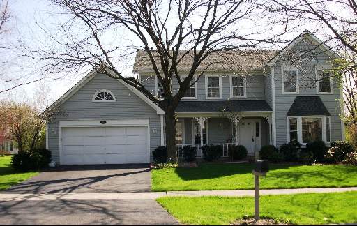 604 Cassin Road Naperville, IL 60565 - Photo 1 of 1 a front view of a house with a yard and garage