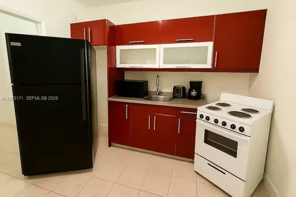 a kitchen with stainless steel appliances granite countertop a refrigerator and a stove
