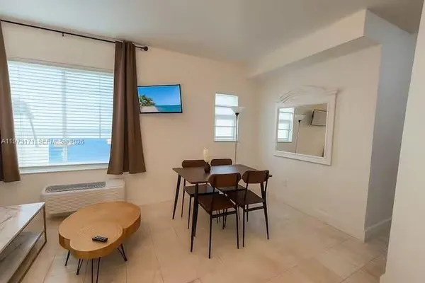 a dining room with furniture and window