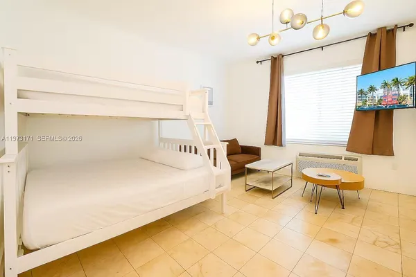 a spacious bedroom with a bed and a couch