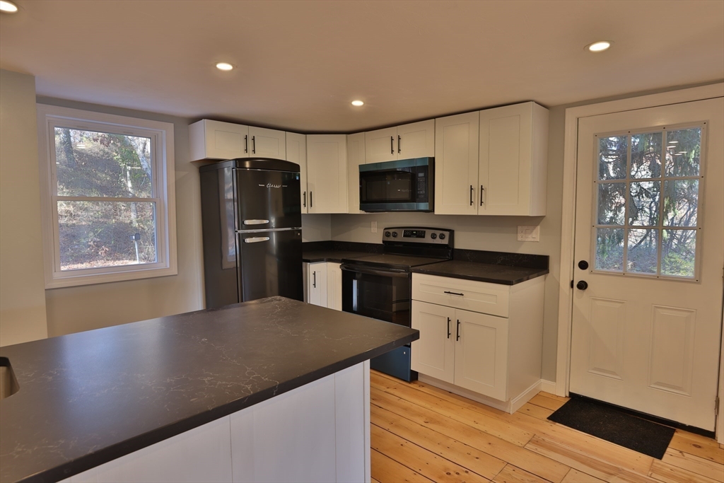 25 Center Hill Road Plymouth, MA 02360 - Photo 4 of 27 a kitchen with a refrigerator and a stove top oven