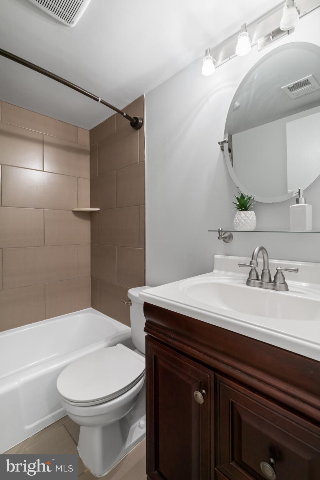 7105 Galgate Drive Springfield, VA 22152 - Photo 12 of 36 a bathroom with a sink a toilet and shower