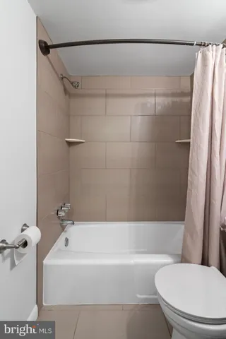 a bath room with a toilet and a bath tub