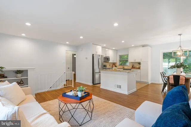 a living room with furniture kitchen view and a table