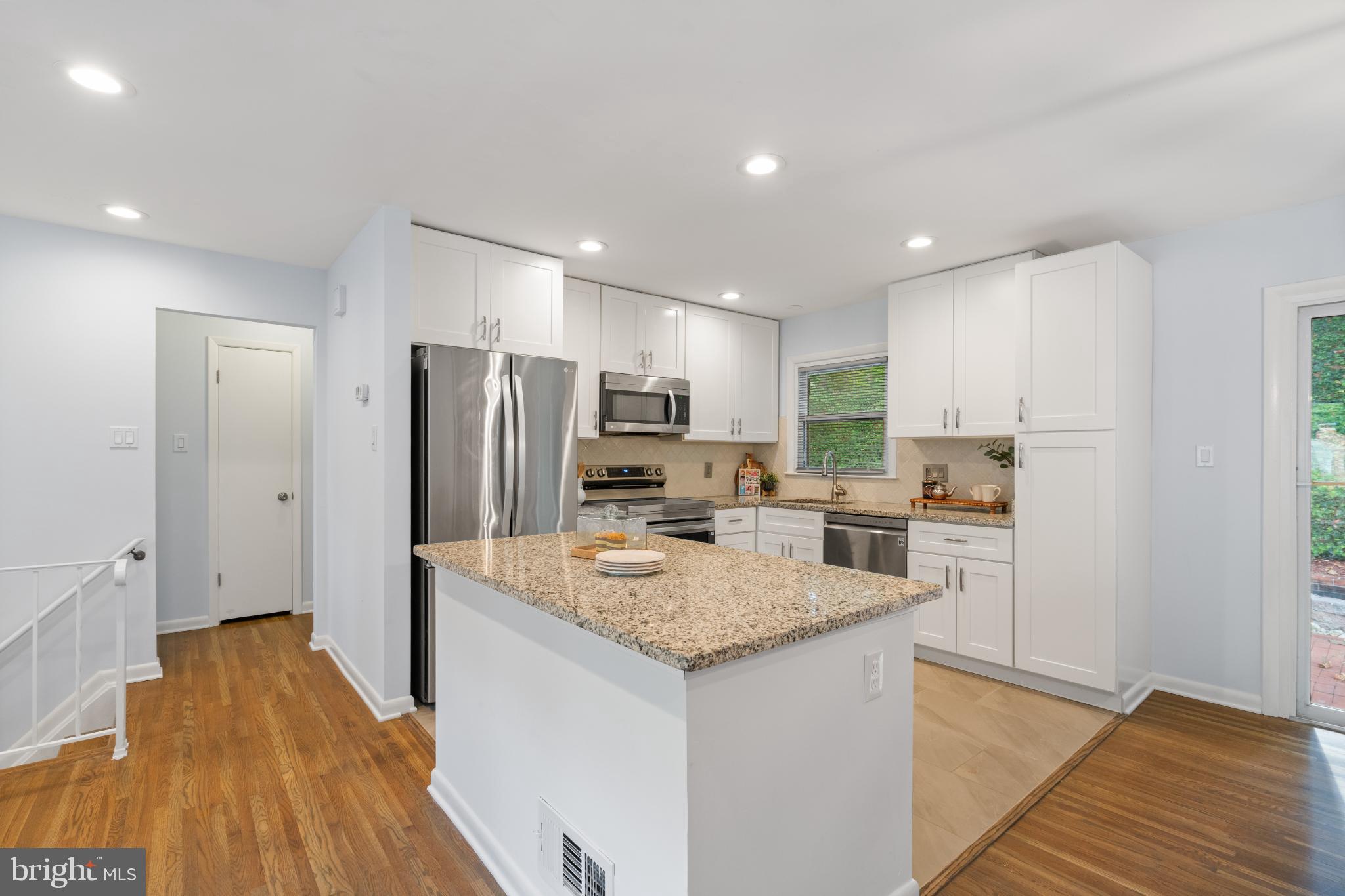 7105 Galgate Drive Springfield, VA 22152 - Photo 18 of 36 a kitchen with stainless steel appliances granite countertop a refrigerator and a stove top oven
