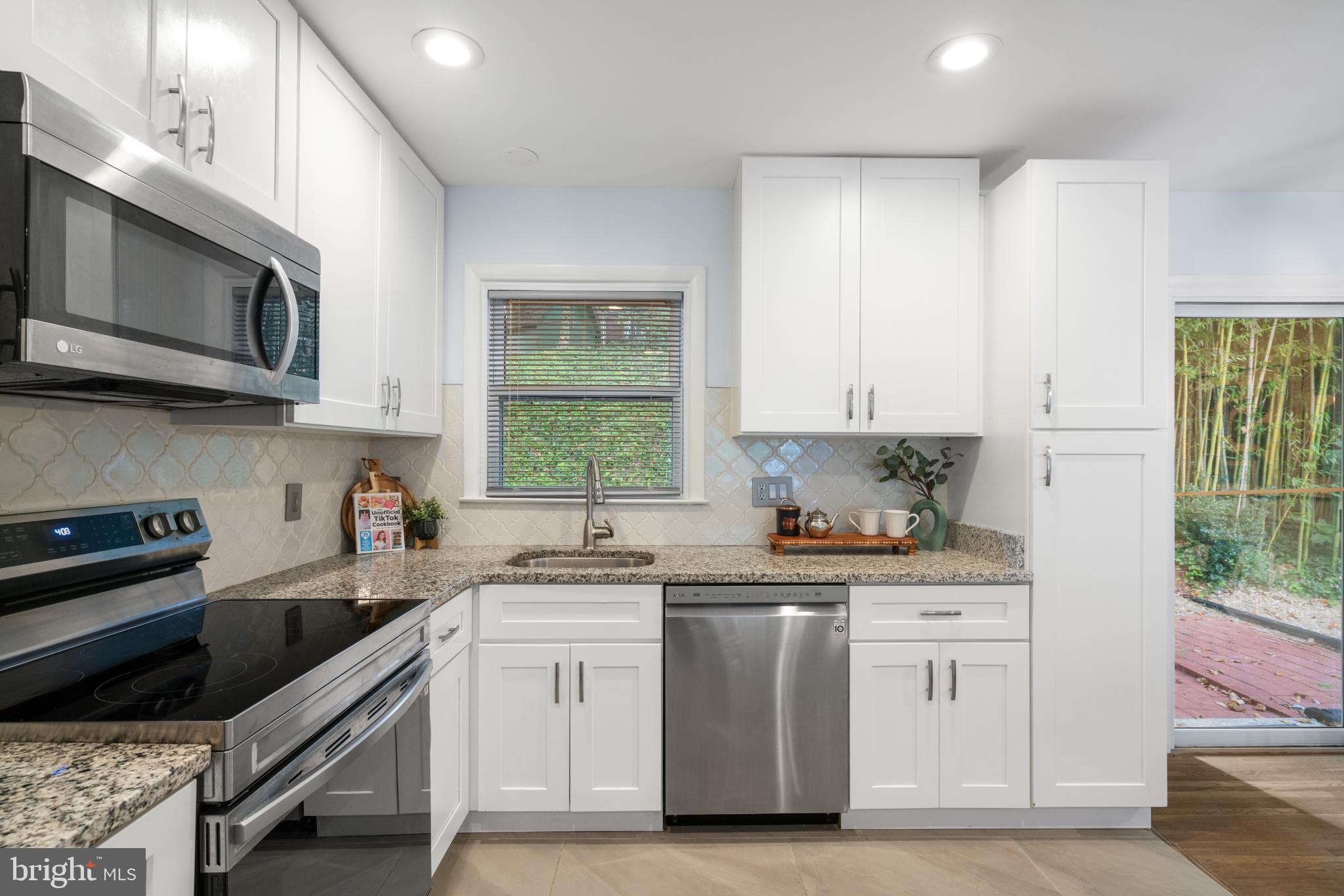 7105 Galgate Drive Springfield, VA 22152 - Photo 20 of 36 a kitchen with stainless steel appliances a sink stove and cabinets