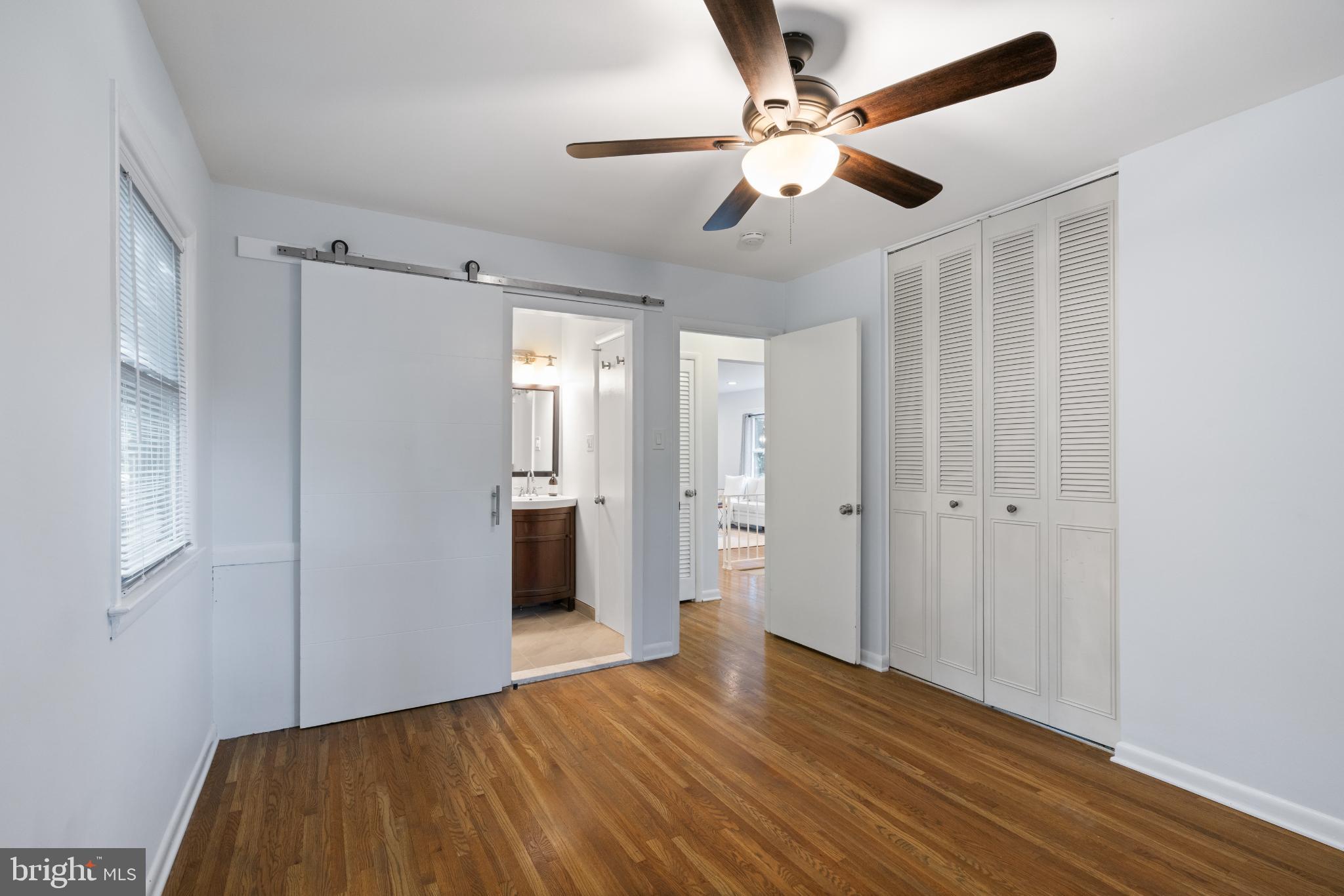 7105 Galgate Drive Springfield, VA 22152 - Photo 28 of 36 a view of a livingroom with wooden floor and a ceiling fan
